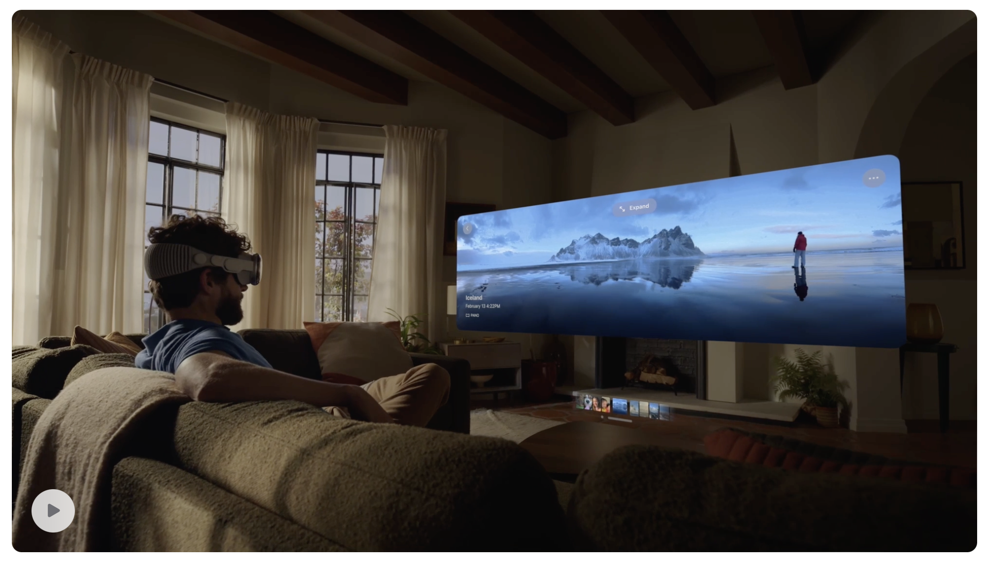 A man sat in a living room looking at a panorama through his Apple Vision Pro